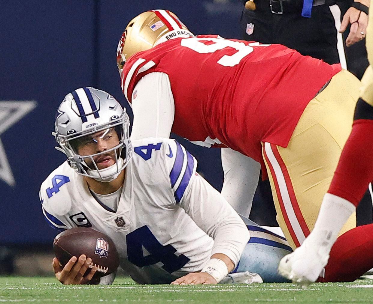 Dallas Cowboys quarterback Dak Prescott (4) tries to get up after he was sacked by San...