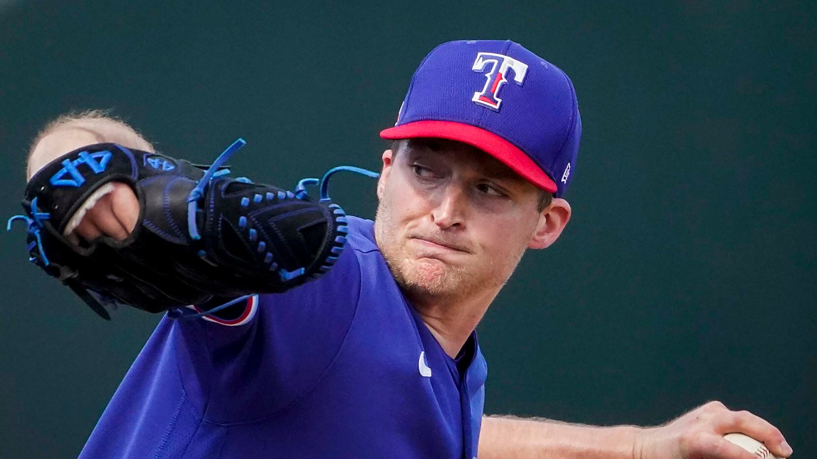 Texas Rangers pitcher Wes Benjamin delivers during the third inning of a spring training...