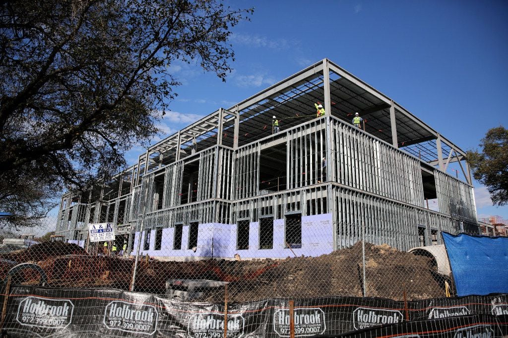 Workers construct Highland Park ISD's fifth elementary school along Durham Street in Dallas...