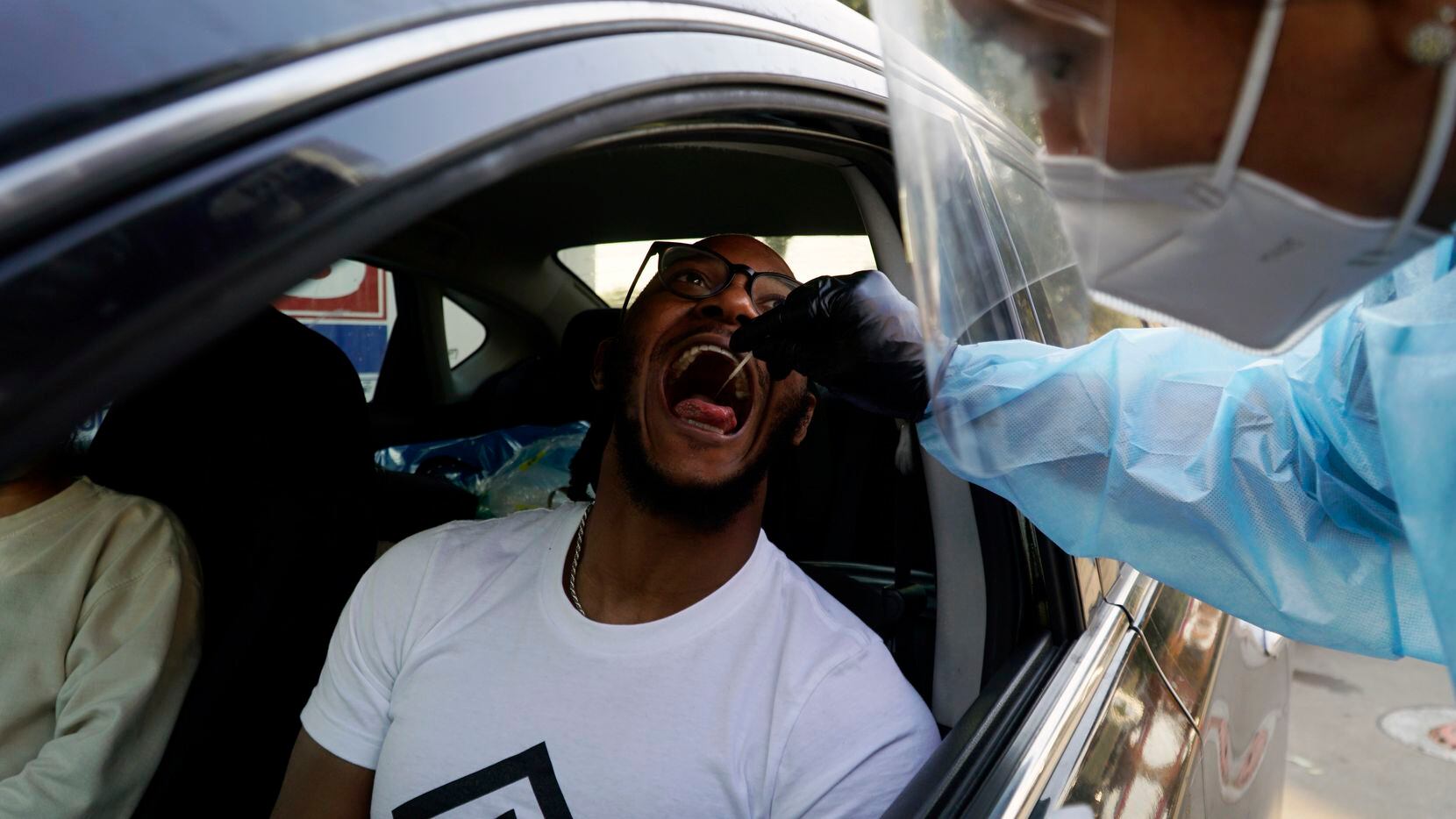 Antoine Howard gets a Covid test "Go Get Tested" location at a Shell station in Arlington,...