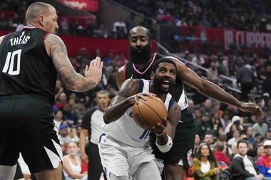 Dallas Mavericks' Kyrie Irving (11) is defended by Los Angeles Clippers' Daniel Theis (10)...