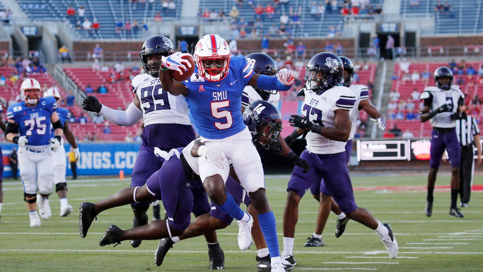Southern Methodist Mustangs wide receiver Danny Gray (5) scores a touchdown as Stephen F. Austin Lumberjacks defensive back Kris McCune (14) fails to stop him during the first half of their home opener at Ford Stadium in Dallas, on Saturday, September 26, 2020.