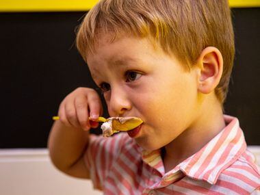 Tripp Selking, 3, enjoys a cup of chocolate ice cream with whipped cream and sprinkles at...