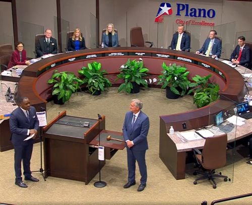 Plano's outgoing mayor, Harry LaRosiliere (front left) talks with new Mayor John Muns during...