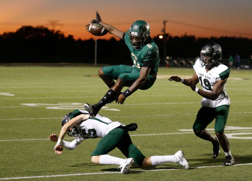 DeSoto Eagles Samari Collier (6) leaps over Mansfield Lake Ridge's Jaxson Lyness (15) as Mansfield Lake Ridge's Andrew Awe (19) closes in on a run play during the first half of play at Eagle Stadium in DeSoto, Texas on Friday, September 27, 2019. (Vernon Bryant/The Dallas Morning News)