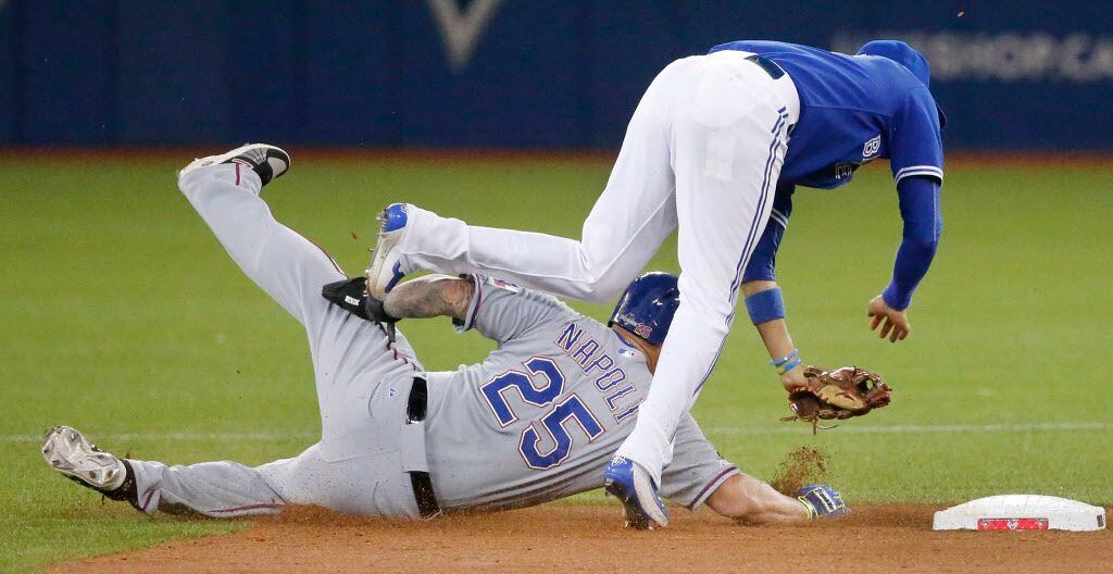 Texas Rangers first baseman Mike Napoli (25) goes in hard to break up a double play in the...
