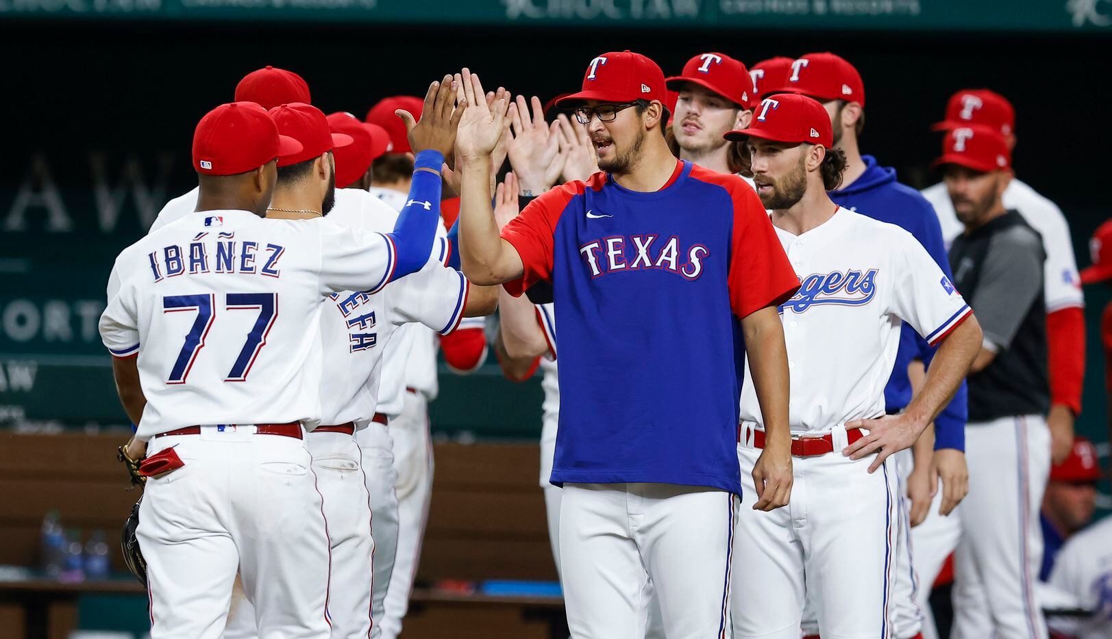 The Texas Rangers celebrate an 8-3 win over the Oakland Athletics after a baseball game in...