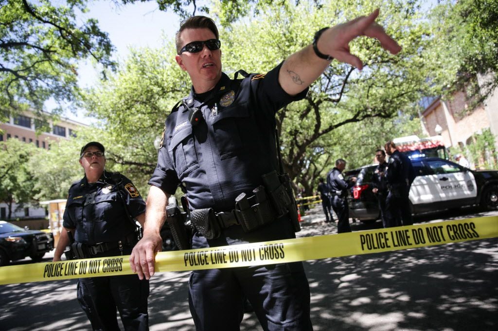 Law enforcement officers secure the scene of a stabbing that occurred on the UT campus on...