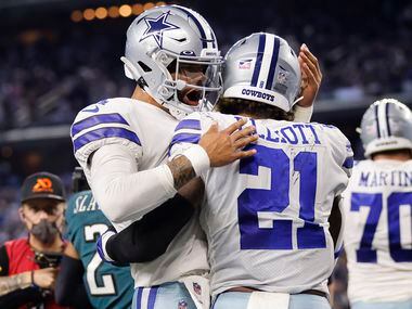 Dallas Cowboys quarterback Dak Prescott (4) congratulators running back Ezekiel Elliott (21)...