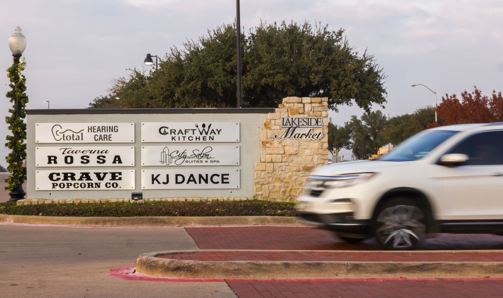 Traffic moves by the entrance to Lakeside Market along Preston Road in Plano on Dec. 7.