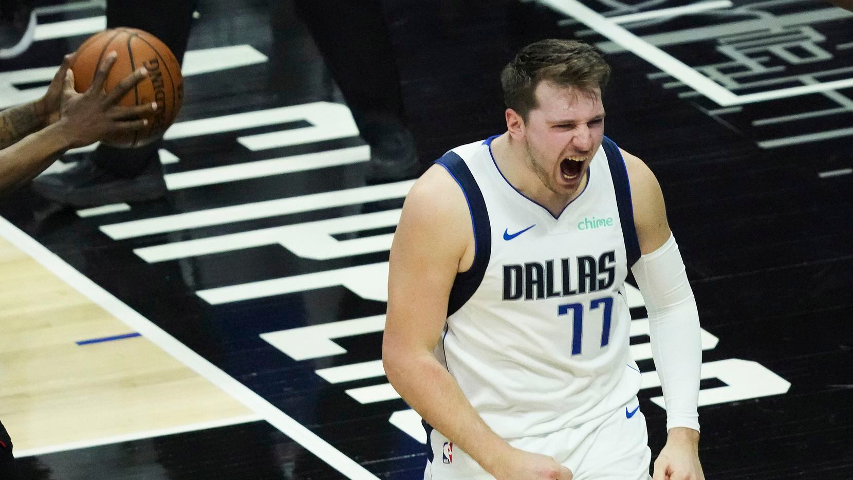 Dallas Mavericks guard Luka Doncic (77) reacts after picking up a basket and a foul against...