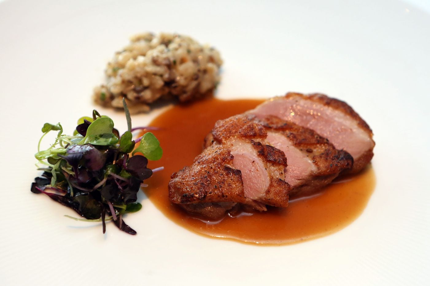 The fifth course was duck breast in a juniper berry-scented rose wine sauce. Avila served it...