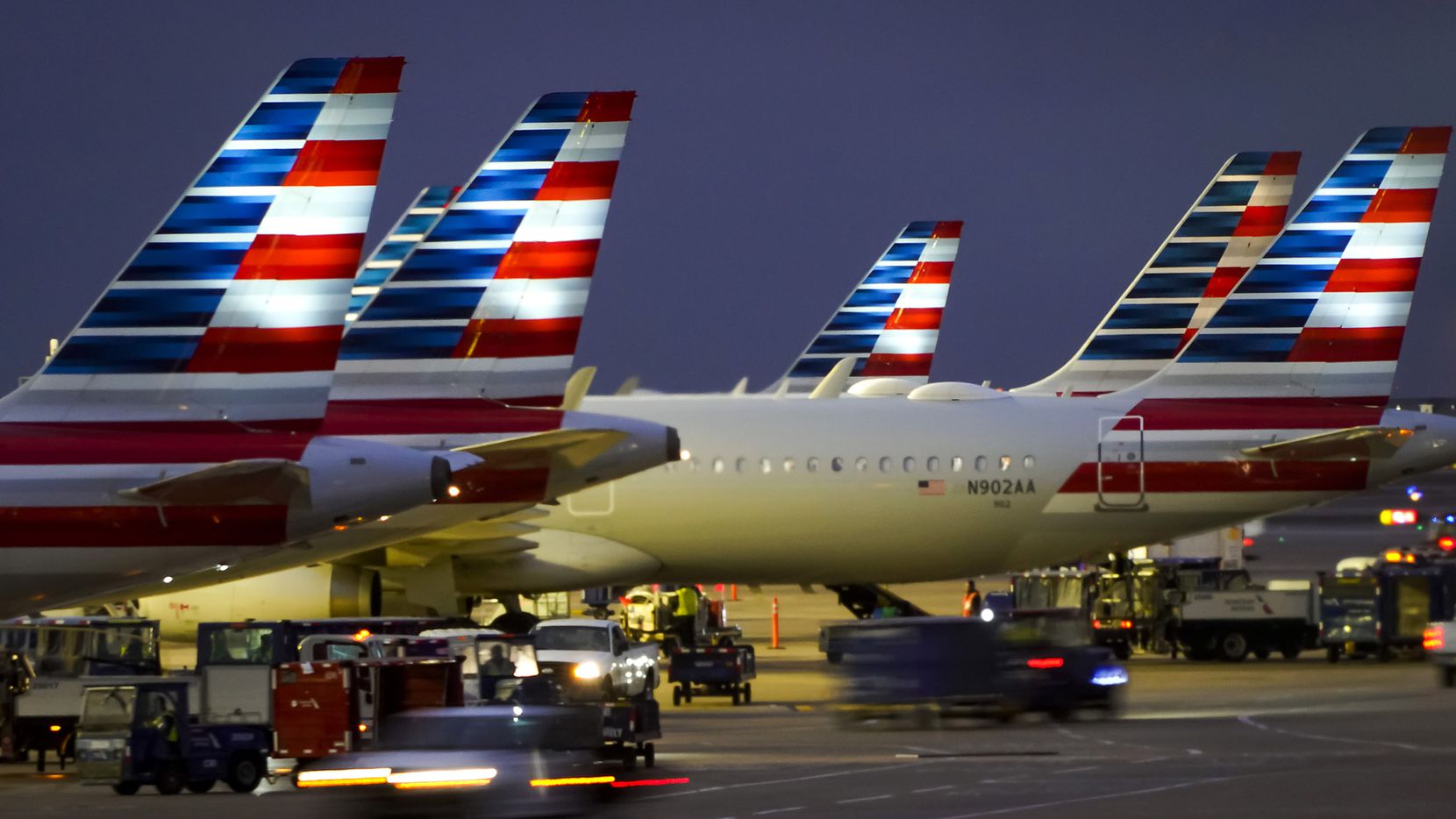American Airlines planes are seen at the gates of Terminal C at DFW Airport on Friday, Jan....