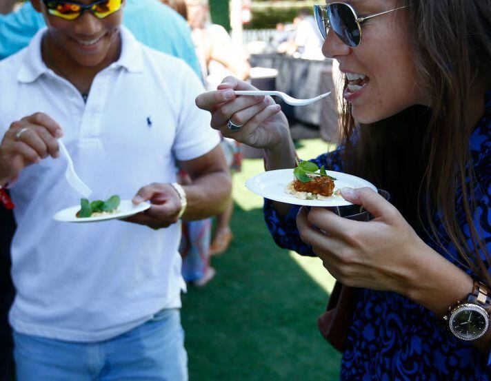 Wei Wong and Marisa Terpkosh sample Blacken Red Snapper at the Park & Palate 2015 event at...