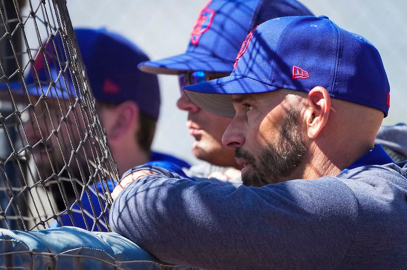 Texas Rangers manager Chris Woodward watches batting practice during a spring training...