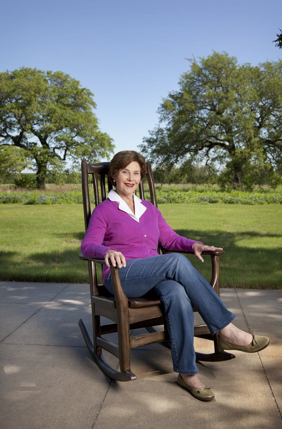 Former First Lady Laura Bush photographed on April 26, 2010, at the ranch in Crawford, Texas. She is seated in a rocking chair that was part of a custom made pair given to the President and First Lady by senior staff on their last Christmas in office. The wood for the chairs is from their ranch. 