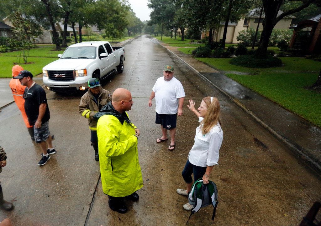 Dickinson, Texas mayor Julie Masters (right) visits with a police officer about getting to...