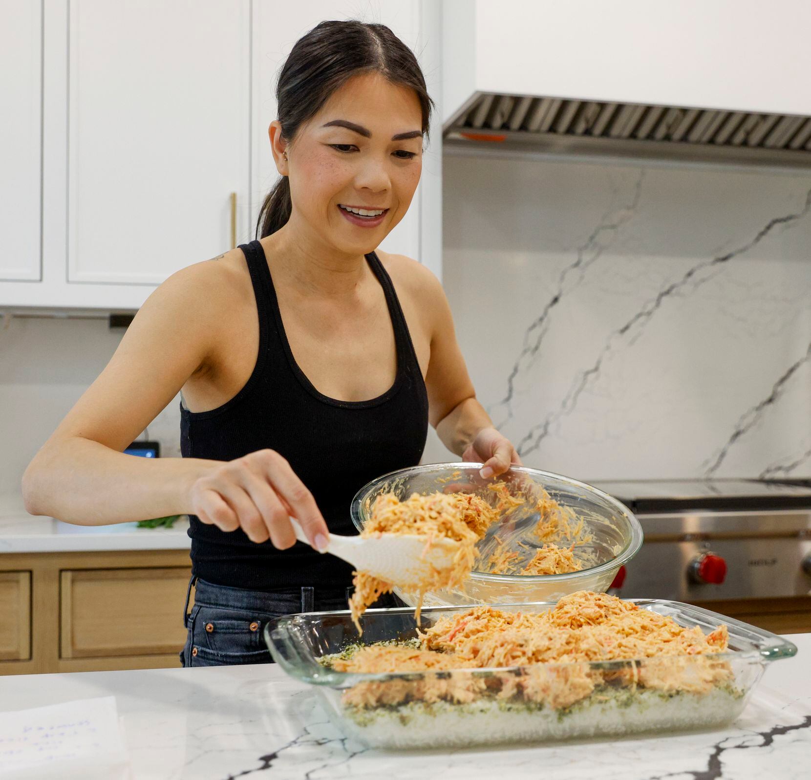 Alissa Nguyen puts a mix of salmon, imitation crab with spicy mayo on top of rice.