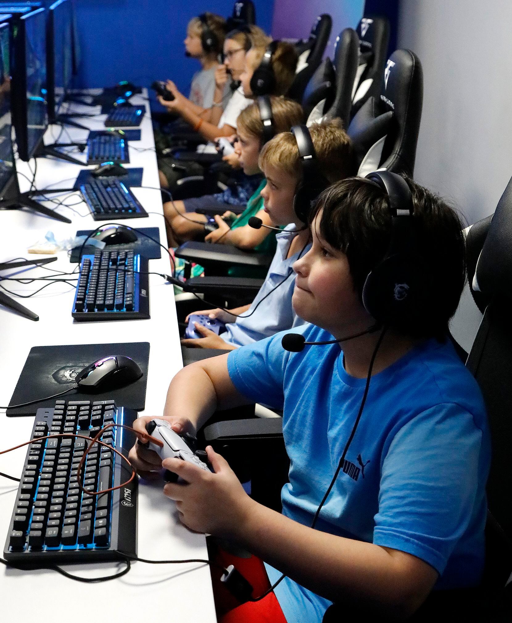 Jacobi Garcia, 12, of Frisco, plays online video games Friday at Stonebriar Country Club in...