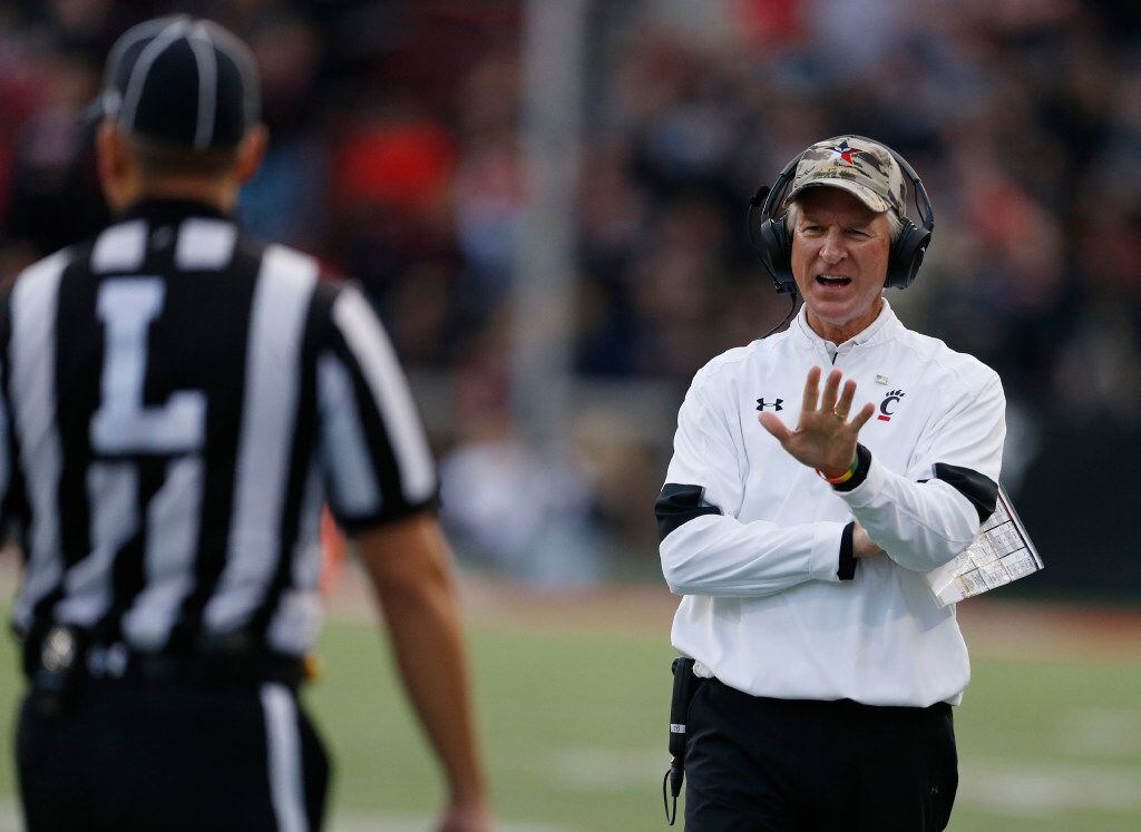 Cincinnati head coach Tommy Tuberville talks with a line judge during the second half of an NCAA college football game against Brigham Young , Saturday, Nov. 5, 2016, in Cincinnati. Brigham Young won 20-3. (AP Photo/Gary Landers)