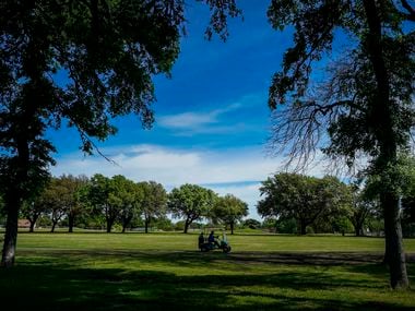 A golfer drive a cart along a fairway at Golf Club of Dallas on Wednesday, April 1, 2020, in Dallas. Due to coronavirus concerns players are limited to one person per cart at the course.