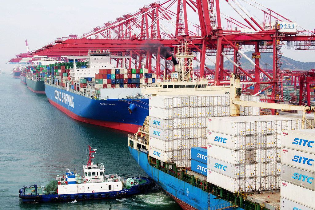 A barge pushes a container ship earlier this month to the dockyard in Qingdao in eastern...