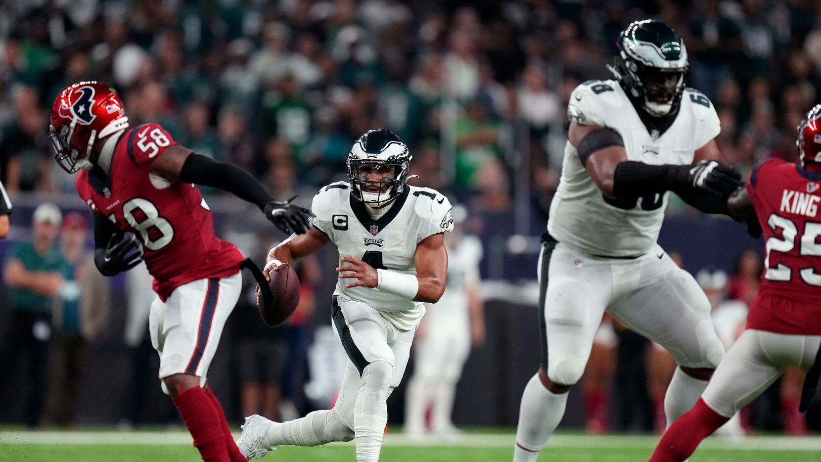 Philadelphia Eagles quarterback Jalen Hurts (1) scrambles in the first half of an NFL...