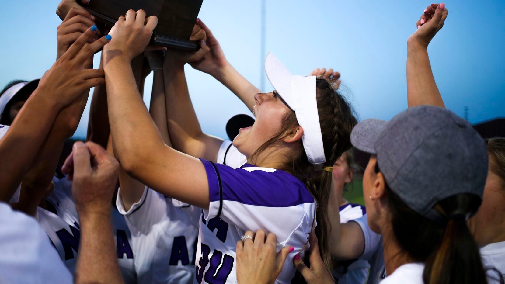 Anna's Hannah Morland hoists a trophy after their 11-2 victory in a Class 4A Region II...
