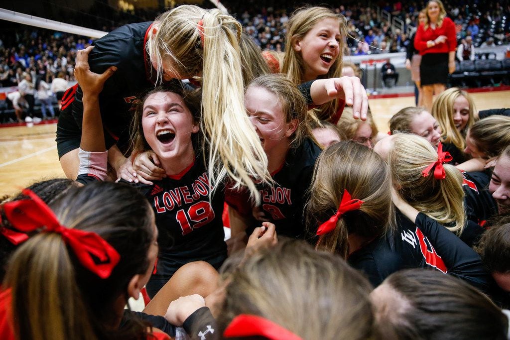 Lexie Collins (19) (left) emerges from the group dog pile after winning a class 5A...