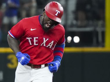 Texas Rangers center fielder Adolis Garcia celebrates as he rounds the bases after hitting a solo home run to tie the game during the seventh inning against the Minnesota Twins at Globe Life Field on Friday, June 18, 2021.