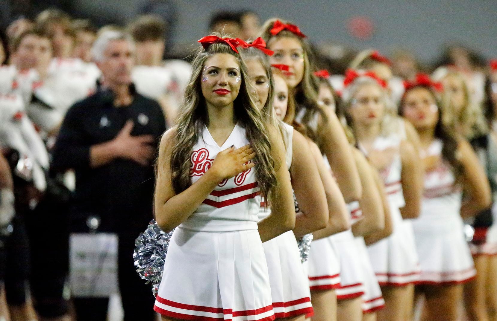 Lovejoy High School cheerleader stand at attention before kickoff  as Lovejoy High School...