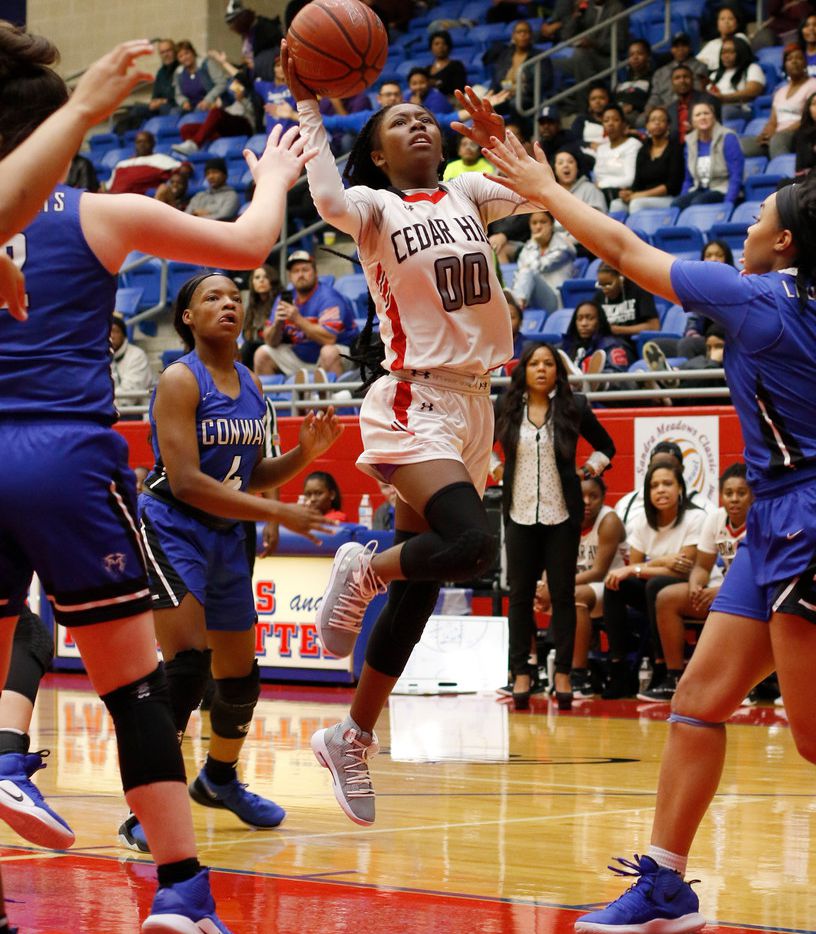 Cedar Hill guard Makalah Robinson (00) emerges from a pack of Conway, Arkansas defenders to get off a shot during second half action. The two teams played in the championship game in the Sandra Meadows Classic girls basketball tournament held at the Sandra Meadows Memorial Arena in Duncanville on December 29, 2018. (Steve Hamm/ Special Contributor)