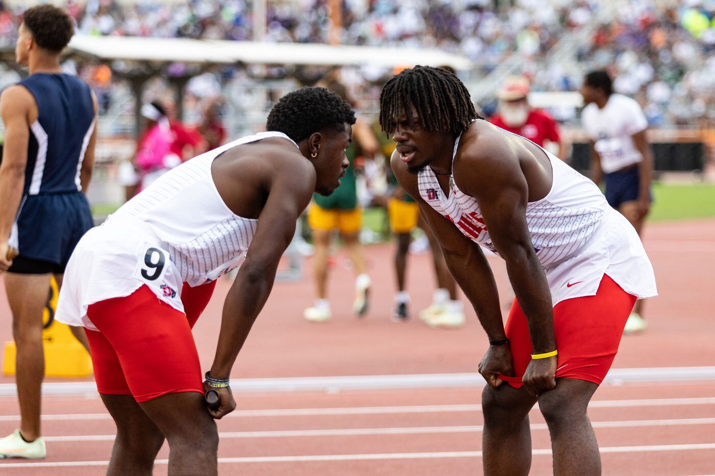 Jaylen Washington, left, and Pierre Goree of Duncanville speak after the boys’ 4x00-meter...
