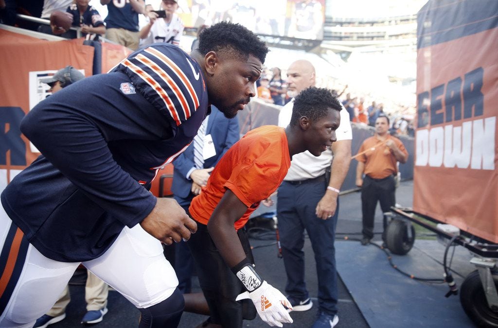 CHICAGO, ILLINOIS - AUGUST 08: Khalil Mack #52 of the Chicago Bears makes his way onto the...