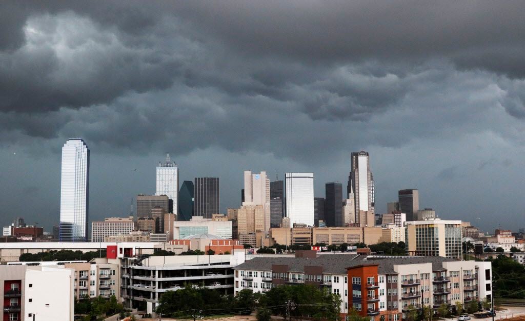 Clouds gather over the Dallas skyline before it rained in North Texas on Friday, July 15,...