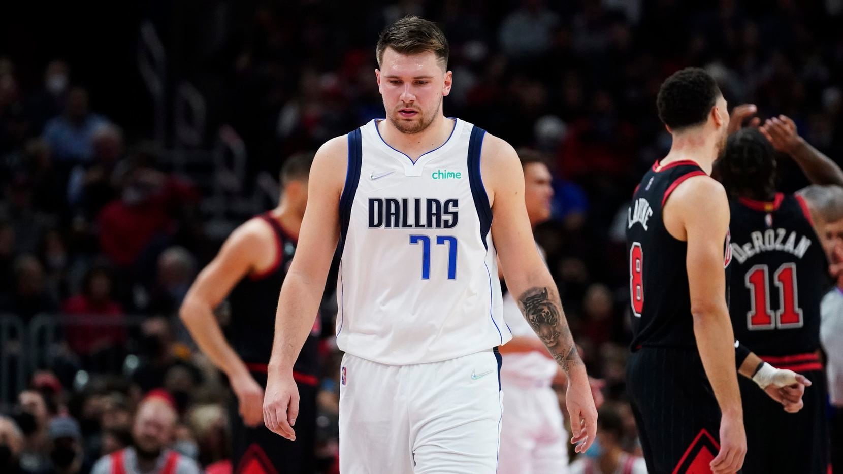 Dallas Mavericks guard Luka Doncic looks down as he walks on the court during the first half of an NBA basketball game against the Chicago Bulls in Chicago, Wednesday, Nov. 10, 2021. The Chicago Bulls won 117-107.
