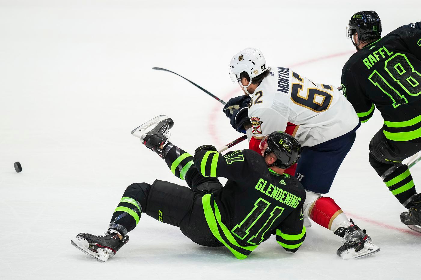 Dallas Stars center Luke Glendening (11) is knocked to the ice by Florida Panthers...