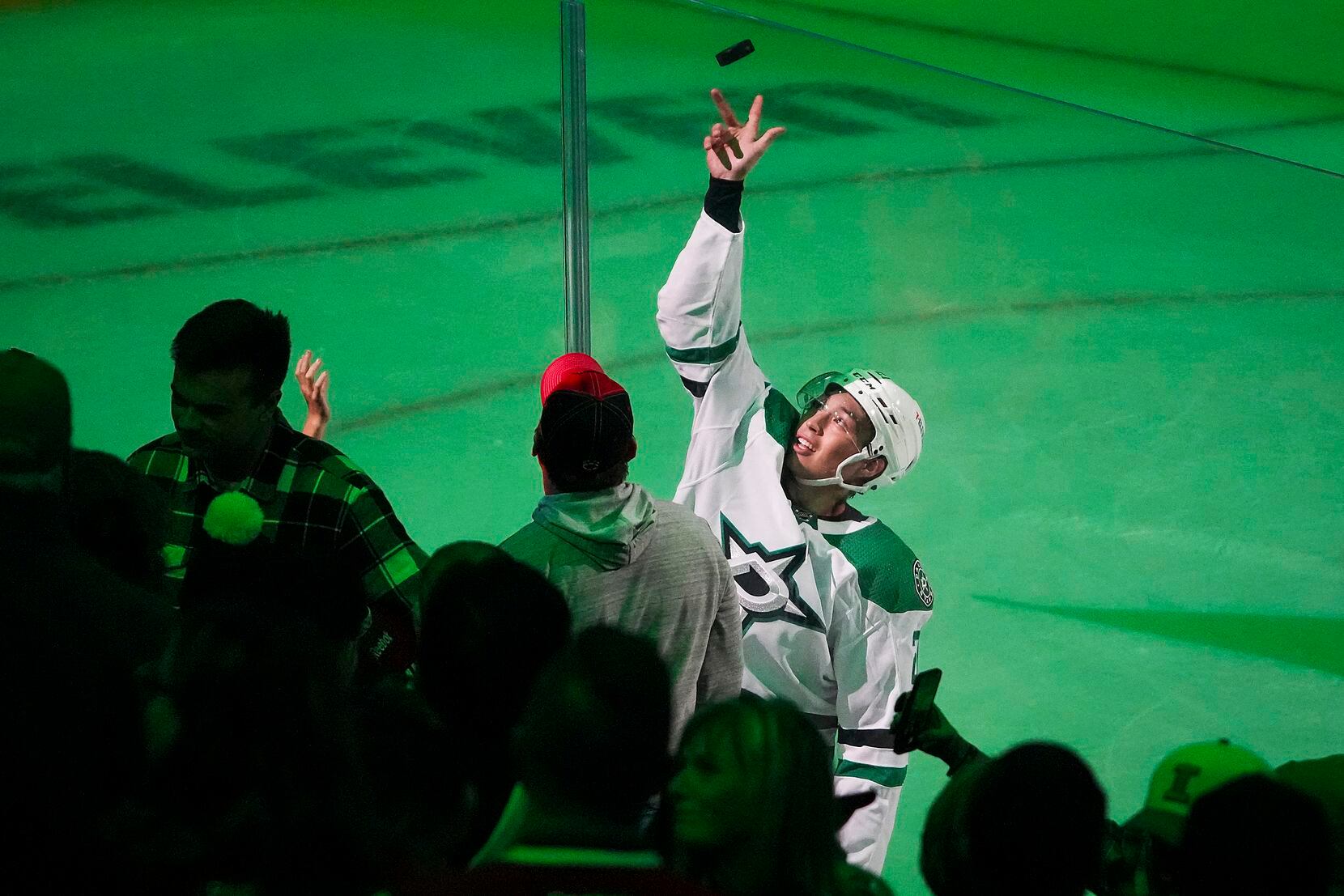 Dallas Stars left wing Jason Robertson tosses a puck to the crowd after being recognized as...