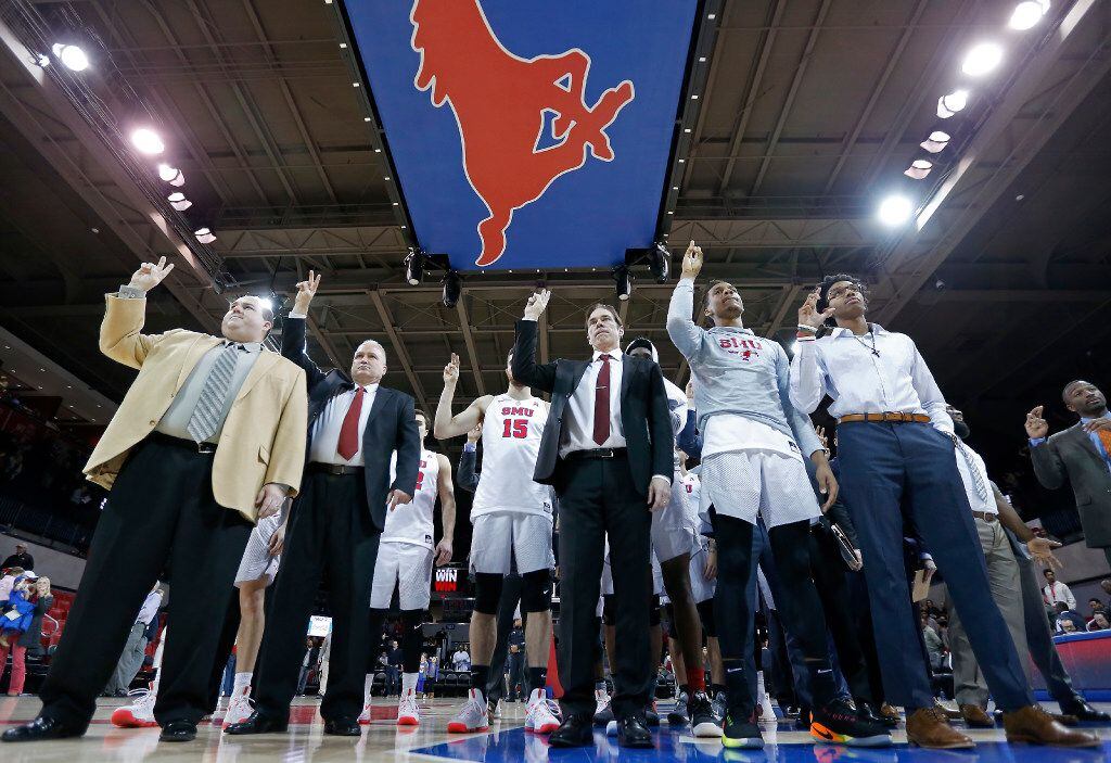 SMU Mustangs coaches and players celebrate a 84-65 win over South Florida at Moody Coliseum...
