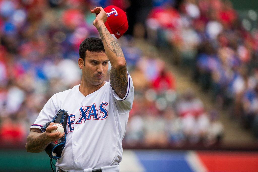 Rangers relief pitcher Matt Bush reacts to a home run he gave up in the seventh inning of a...