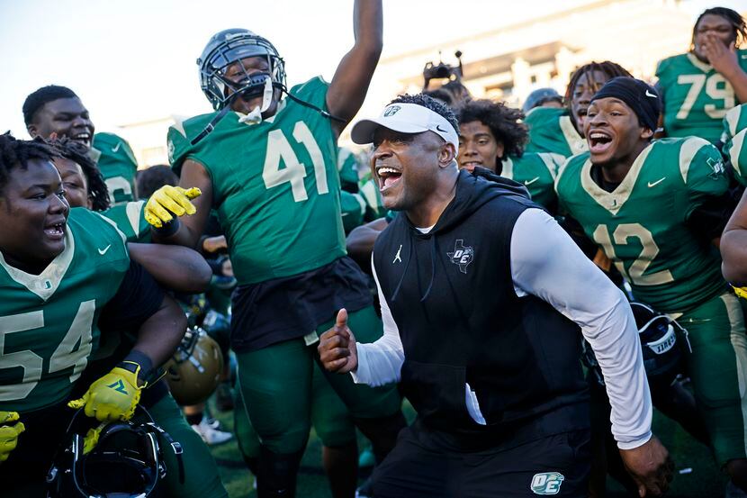 DeSoto head coach Claude Mathis, center, celebrates with his players after their 45-38...