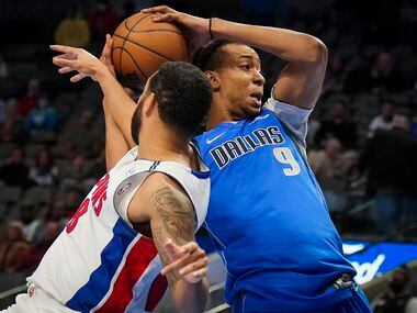 Dallas Mavericks center Moses Brown (9) is fouled by Detroit Pistons forward Trey Lyles (8)...