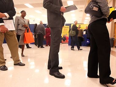Job seekers wait to have their résumés critiqued by a professional during a Career Expo at the Richardson Civic Center in 2019.