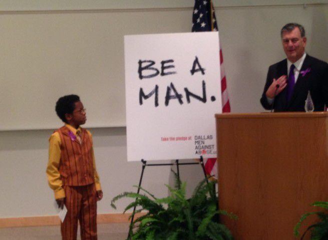  Mayor Mike Rawlings and David Williams, 12, at a press conference opposing domestic violence.