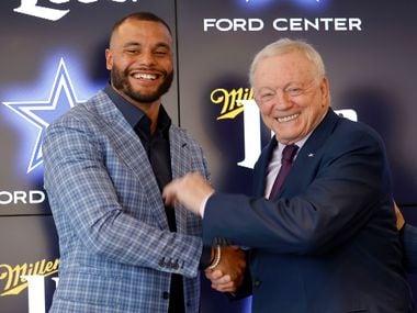 Dallas Cowboys quarterback Dak Prescott (left) and Dallas Cowboys owner Jerry Jones shake hands following a press conference at The Star in Frisco, Texas, Wednesday, March 10, 2021.