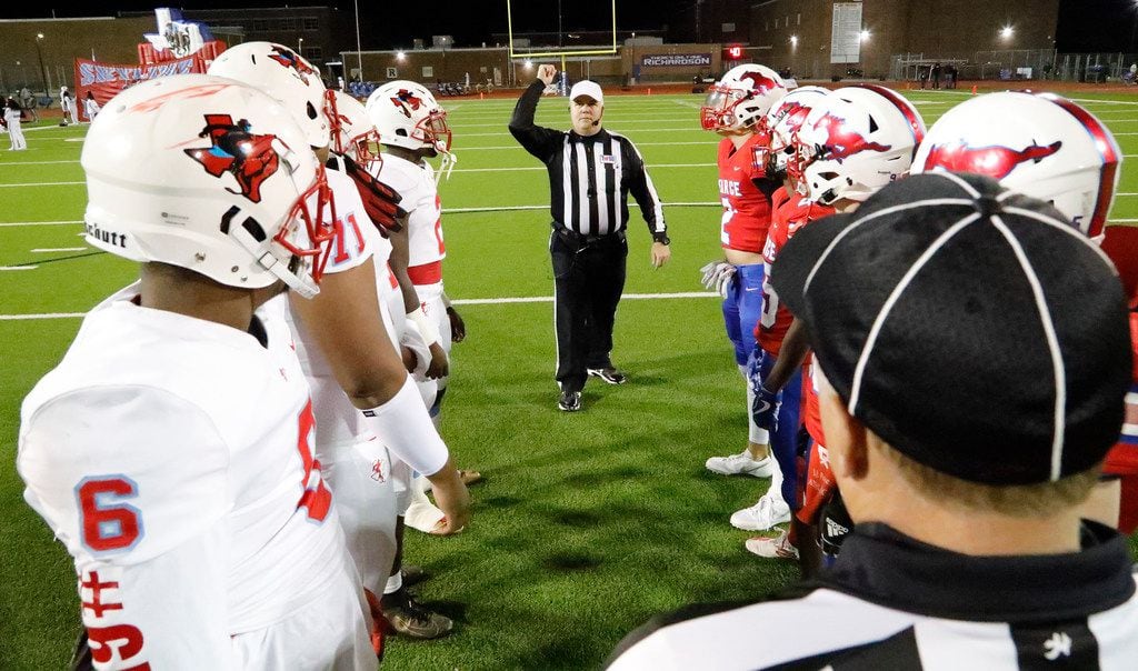 Team captains gather at midfield for the coin toss as J.J. Pearce High School hosted Skyline...