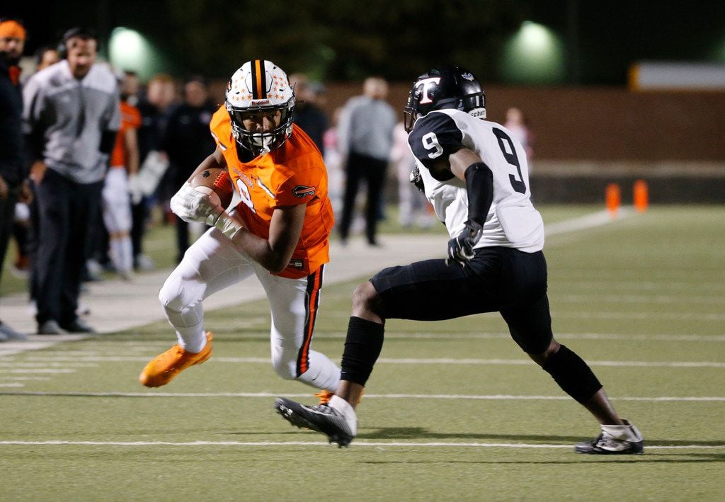 Haltom receiver Jace Washington catches a pass in front of Euless Trinity defender Camryn...