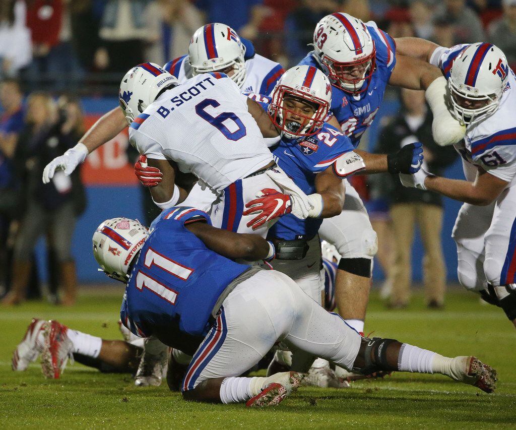 Southern Methodist Mustangs linebacker Kyran Mitchell (11) and safety Delano Robinson (24) make a tackle on Louisiana Tech Bulldogs running back Boston Scott (6) in the first quarter during the NCAA 2017 DXL Frisco Bowl between the Louisiana Tech Bulldogs and the SMU Mustangs at Toyota Stadium in Frisco, Texas Wednesday December 20, 2017. (Andy Jacobsohn/The Dallas Morning News)