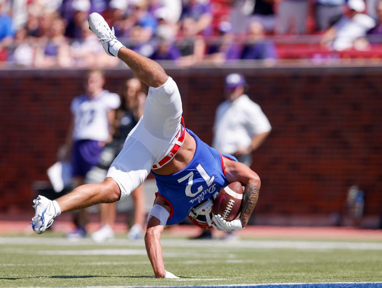 SMU wide receiver Jake Bailey (12) flips towards the goalie after being tackled during the...