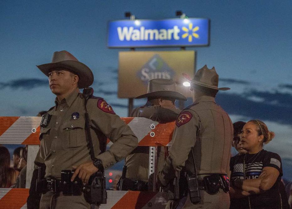 Texas State Troopers keep watch at the makeshift memorial for victims of the shooting that left 22 people dead at an El Paso Walmart. Photo taken on August 6, 2019, three days after the rampage.